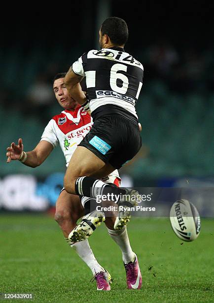 Benji Marshall of the Tigers clashes with Darius Boyd of the Dragons during the round 22 NRL match between the Wests Tigers and the St George...