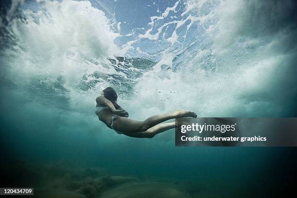 girl swimming in waves - sea swimming stock pictures, royalty-free photos & images