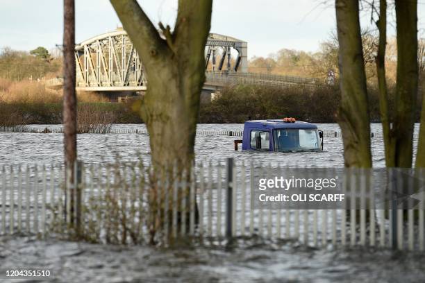 Flood water covers surrounds a lorry, stuck on a flooded road in Snaith, northern England on March 1, 2020 after Storm Jorge brought more rain and...