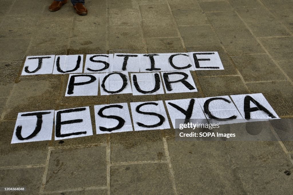 A sign saying "Justice for Jessyca" on the ground.
People...