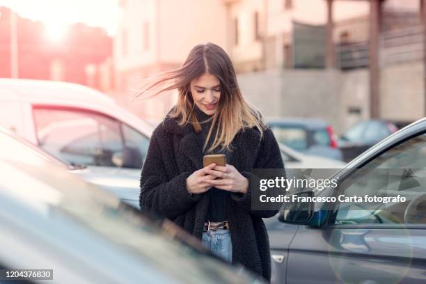 young woman using smartphone - calling on the side road stock pictures, royalty-free photos & images