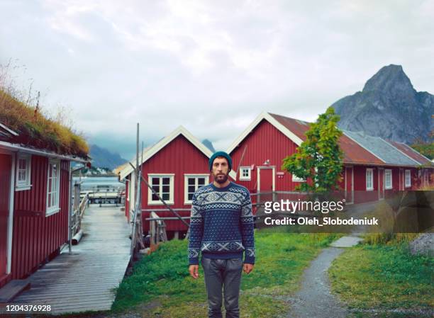 man in reine village in lofoten islands - traditionally norwegian stock-fotos und bilder