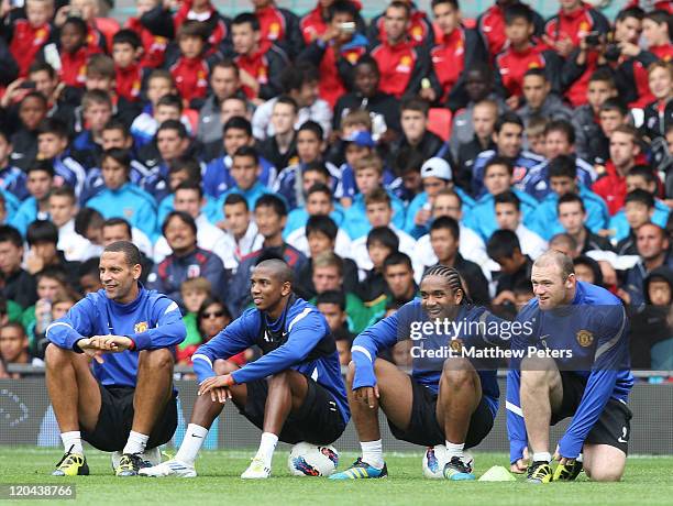 Rio Ferdinand, Ashley Youngm Anderson and Wayne Rooney of Manchester United in action during a first team open training session at Old Trafford on...