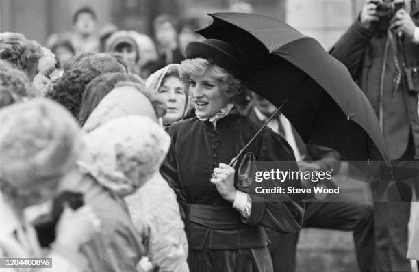 Diana, Princess of Wales , wearing a Caroline Charles outfit with a hat by John Boyd, greeting royal well wishers as she and Charles, Prince of Wales...