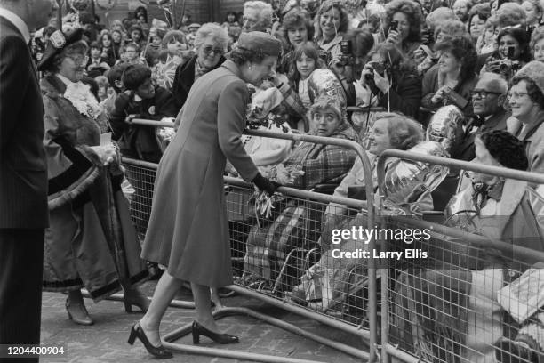 Queen Elizabeth II meeting royal well wishers behind a barrier as she opens the Ealing Broadway Shopping Centre in Ealing, London, England, 7th March...