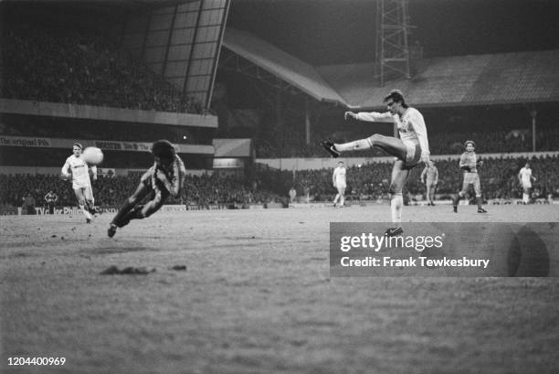 Real Madrid goalkeeper Miguel Angel dives as British footballer Glenn Hoddle shoots for Tottenham Hotspur during their UEFA Cup Quarter Final, First...