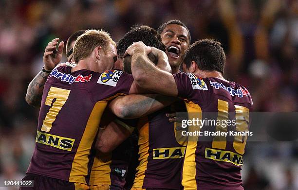 Broncos players celebrate a try by Matt Gillett during the round 22 NRL match between the Brisbane Broncos and the New Zealand Warriors at Suncorp...