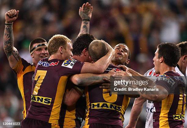 Broncos players celebrate a try by Matt Gillett during the round 22 NRL match between the Brisbane Broncos and the New Zealand Warriors at Suncorp...