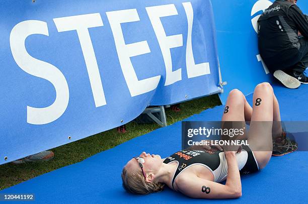 Svenja Bazlen of Germany lays on the floor at the finish line at the end of the Women's Elite Race at the ITU World Championship Triathlon on August...