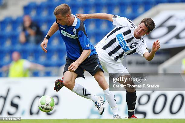 Andreas Hofmann of Aalen tackles Johannes Rahn of Bielefeld during the Third League match between Arminia Bielefeld and VfR Ahlen at the Schueco...