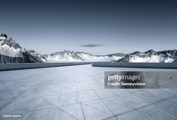 parking lot against snowcapped mountains - parking deck stock pictures, royalty-free photos & images