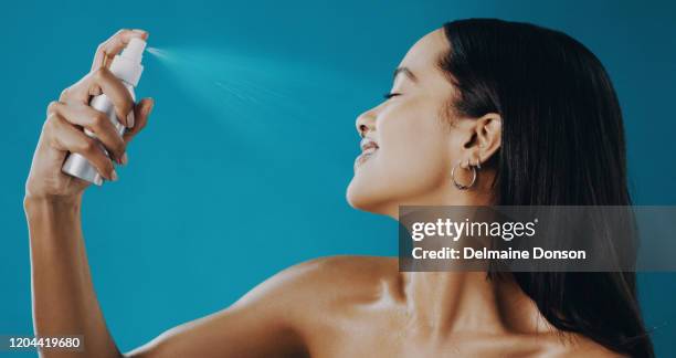 want lasting makeup?this mist is your answer - spraying stock pictures, royalty-free photos & images