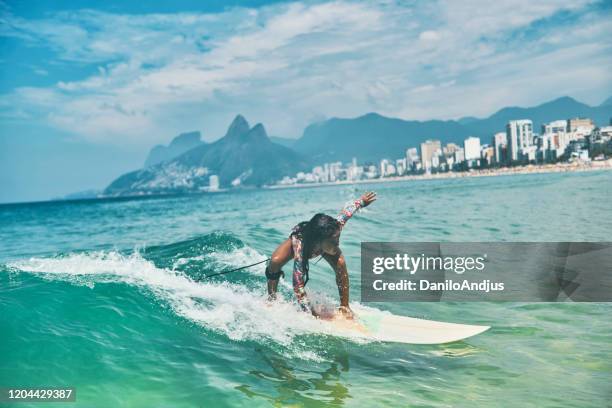 beautiful little surfer rides on surfboard - breaking wave stock pictures, royalty-free photos & images