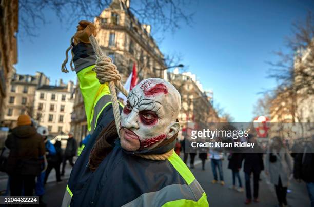Member of the CGT Union marches through the streets of Paris with a noose around his neck on the 9th inter-professional day of strikes and...