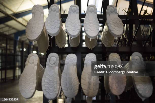 white rubber boots - shoe factory stock-fotos und bilder