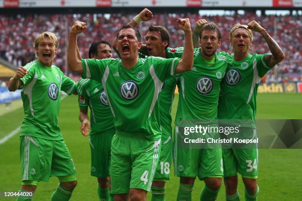 Marcel Schaefer of Wolfsburg celebrates the second goal with his team mates during the Bundesliga match between 1. FC Koeln and VfL Wolfsburg at...