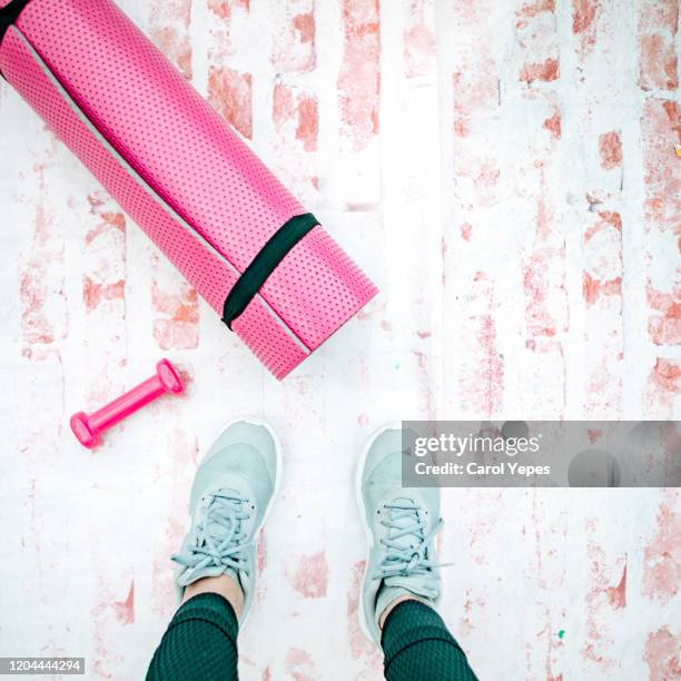 pov. female hand with dumbbell and exercise mat - womens hand weights stock pictures, royalty-free photos & images