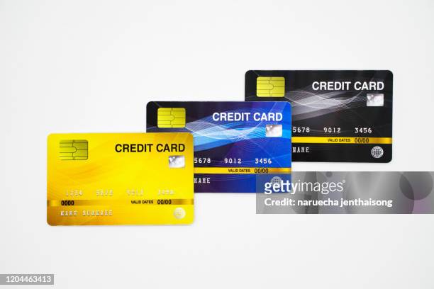 three colored credit cards isolated on white background - credit card and stapel stockfoto's en -beelden