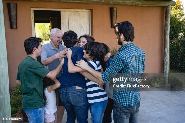 lovely hispanic family embracing together - prima volta imagens e fotografias de stock