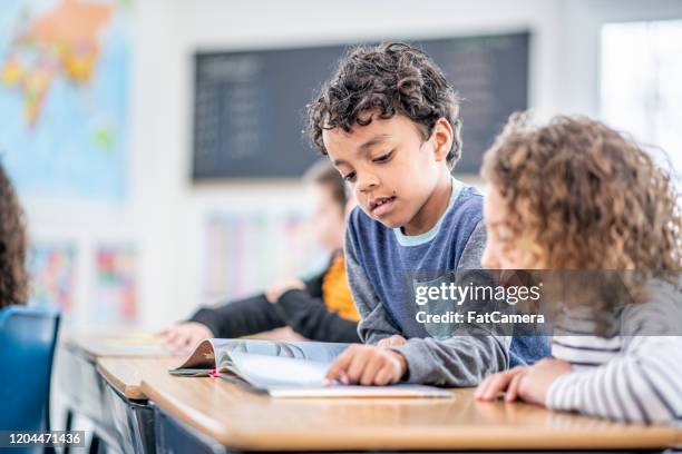 students reading together stock photo - english language stock pictures, royalty-free photos & images