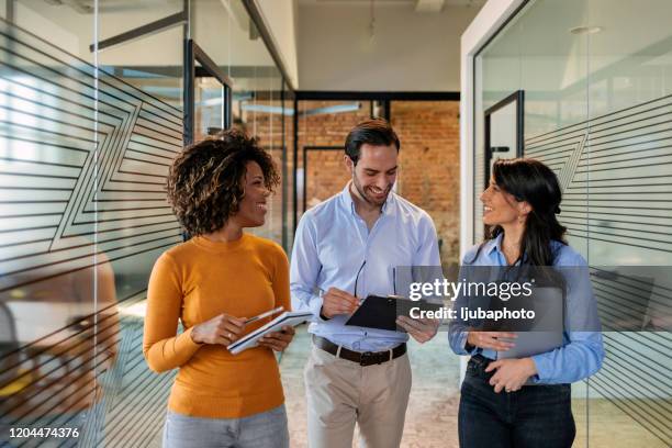 working it out together - three people walking stock pictures, royalty-free photos & images