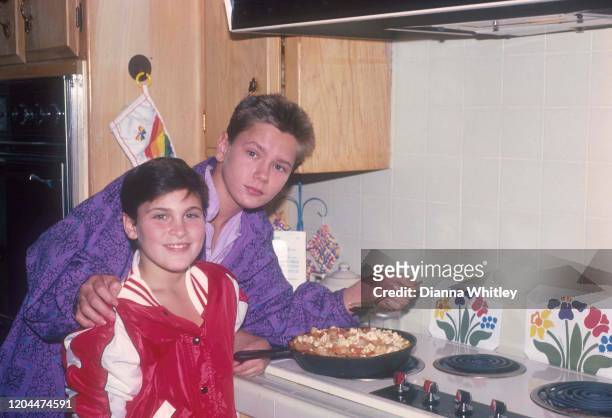 American actors Joaquin and River Phoenix cooking at their home in Los Angeles, California, US, circa 1985.