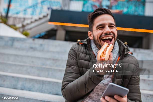 on the lunch break - asian eating hotdog stock pictures, royalty-free photos & images