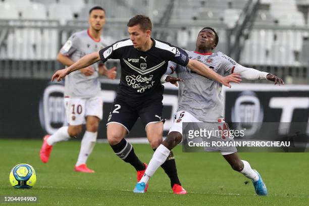 Bordeaux's French forward Nicolas De Preville vies with Nices' Senegalese defender Moussa Wague during a French L1 football match Bordeaux vs Nice on...