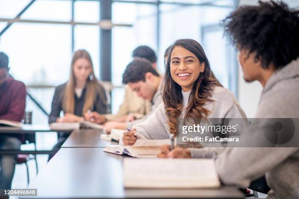 university students in class stock photo - happy college students stock pictures, royalty-free photos & images