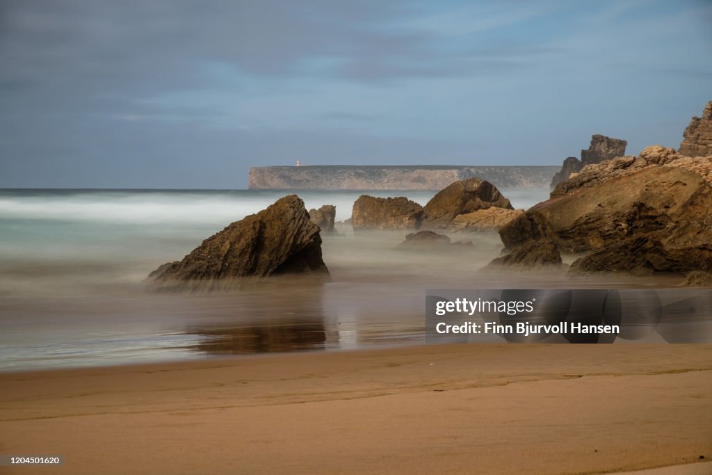 Beach of Sagres on the Algarve coast in Portugal - Caboo Sao Vicente in the background