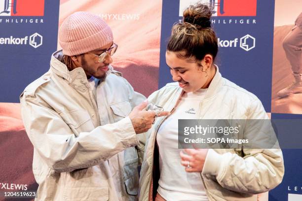 Lewis Hamilton with a fan during the launch party of TommyXLewis at the Dutch warehouse De Bijenkorf, Amsterdam.