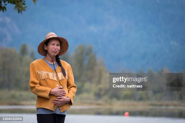 pregnant canadian first nation woman admiring the view - inuit people stock pictures, royalty-free photos & images