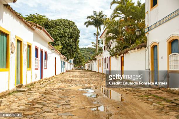 cobblestone streets lined by portuguese colonial buildings, after the rain, against an overcast sky - rio de janeiro street stock pictures, royalty-free photos & images
