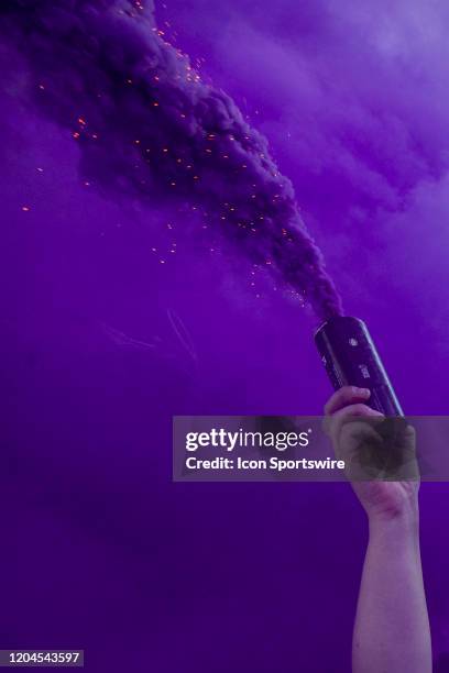 An Orlando fan holds a smoke bomb before the soccer match between Real Salt Lake and Orlando City SC. On February 29 at Exploria Stadium in Orlando...