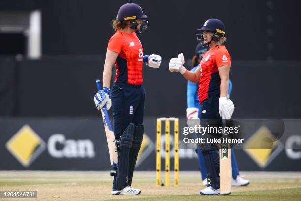 Natalie Sciver of England and Katherine Brunt of England fist bump during game four of the Tri Series Twenty20 series between India and England at...