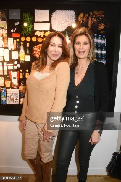 Eva Benhamou, editor in chief of First Luxe Signature and Odile Jagnaud pose with a picture of the Mick Jagger’s dustbin contents during "Paparazzi"...