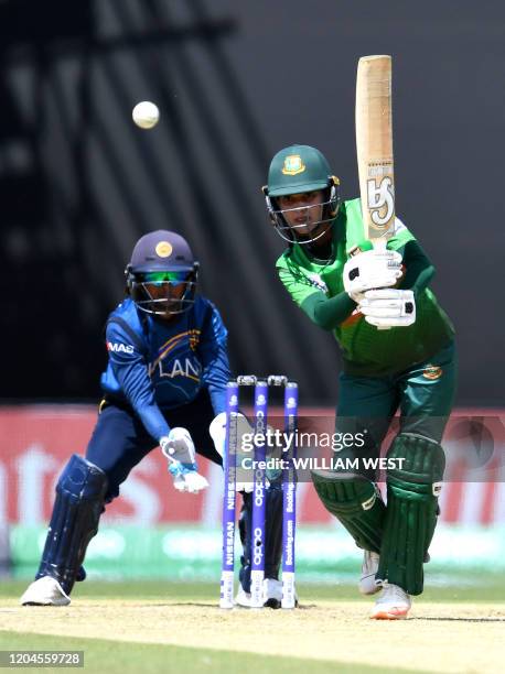 Bangladesh batswoman Nigar Sultana Joty drives a ball as Sri Lanka's wicketkeeper Anushka Sanjeewani looks on during their Twenty20 women's World Cup...