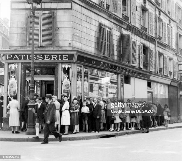 Paris under the occupation in Paris, France in 1943 - Street Richer, a queue under the Occupation.
