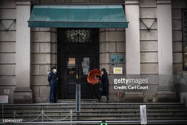 Woman wearing a face mask enters the Bank of Japan in Tokyo's financial district on March 2, 2020 in Tokyo, Japan. Prime Minister Shinzo Abe...