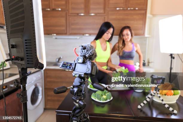 two vloggers filming healthy life style video - nutrition coach stock pictures, royalty-free photos & images