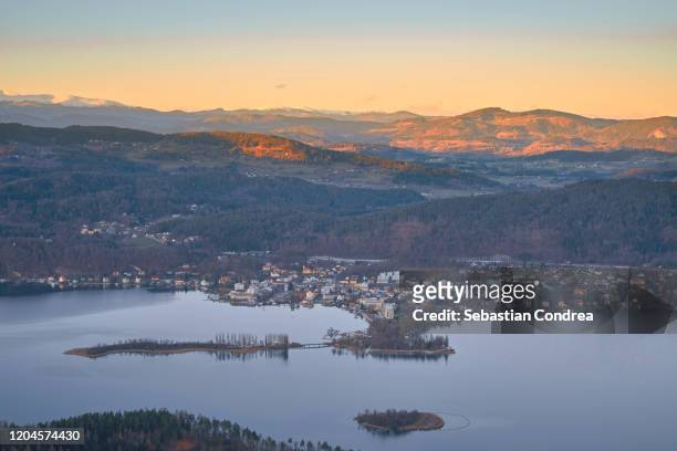 scenic view of islands in lake worthersee from pyramidenkogel tower against sunset sky, pyramidenkogel, carinthia, austria. - carinthia stock pictures, royalty-free photos & images