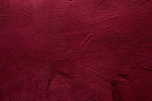 Crimson colored abstract wall background with textures of different shades of crimson