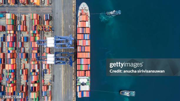 aerial top view container ship crane lifting container for logistic by sea in warehouse. - containerhafen stock-fotos und bilder