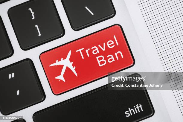 travel ban word and airplane icon on close-up computer keyboard key - immigration law icon stock pictures, royalty-free photos & images