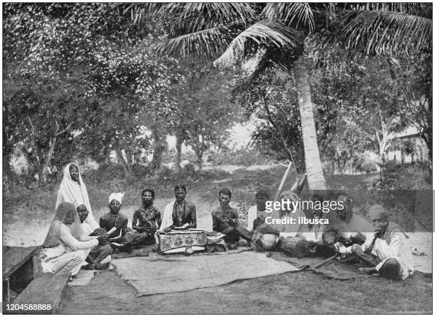 antique photograph of the british empire: sacred book of india in the island of trinidad - india tribal people stock illustrations