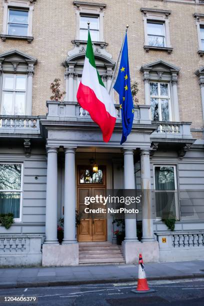 The Italian and EU flag fly outside the Italian embassy in central London on March 1, 2020. The rise in Italy, the main focus of infection in Europe,...