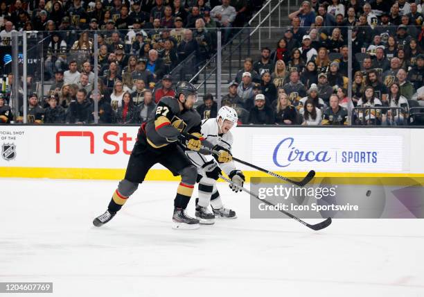 Vegas Golden Knights defenseman Shea Theodore and Los Angeles Kings left wing Austin Wagner battle for control of the puck during the first period of...