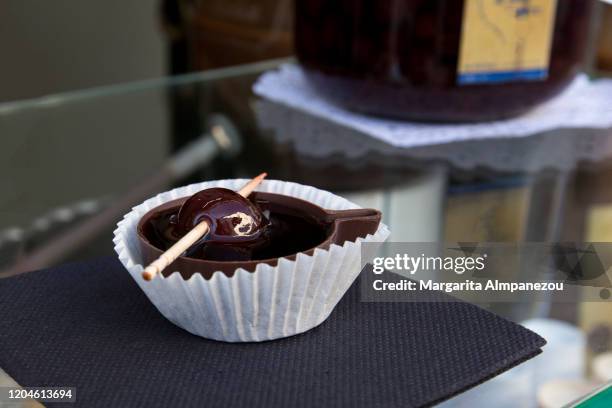 'ginja de obidos' traditional portuguese liqueur served in chocolate cup - sour cherry stock pictures, royalty-free photos & images
