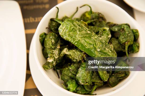 padron peppers served in a bowl - pimientos stock-fotos und bilder