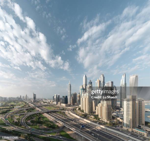 high angle views of urban skyline and skyscrapers at sunrise in dubai uae. - arial view dubai skyline stock pictures, royalty-free photos & images